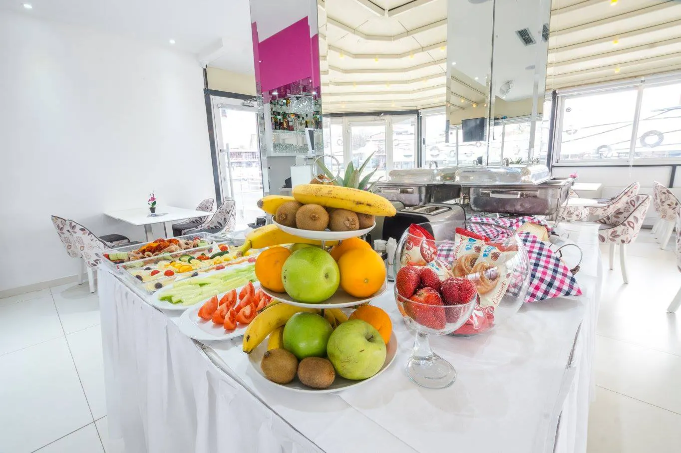 Breakfast buffet with fruit, vegetables and pastries